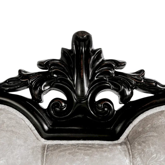 Traditional-style two-seater sofa featuring a button-tufted backrest and decorative throw pillows.