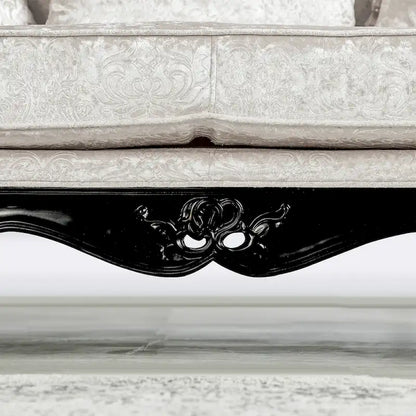 Traditional-style two-seater sofa featuring a button-tufted backrest and decorative throw pillows.