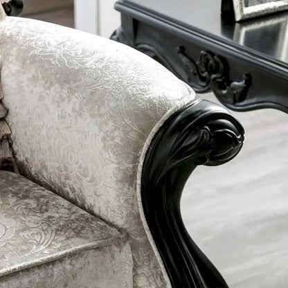 Traditional-style two-seater sofa featuring a button-tufted backrest and decorative throw pillows.