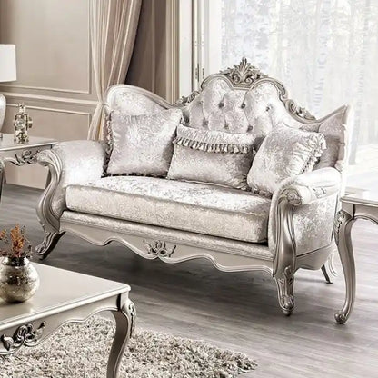 Traditional-style two-seater sofa featuring a button-tufted backrest and decorative throw pillows.