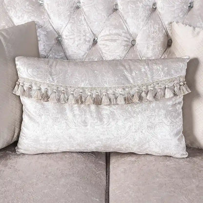 Traditional-style two-seater sofa featuring a button-tufted backrest and decorative throw pillows.