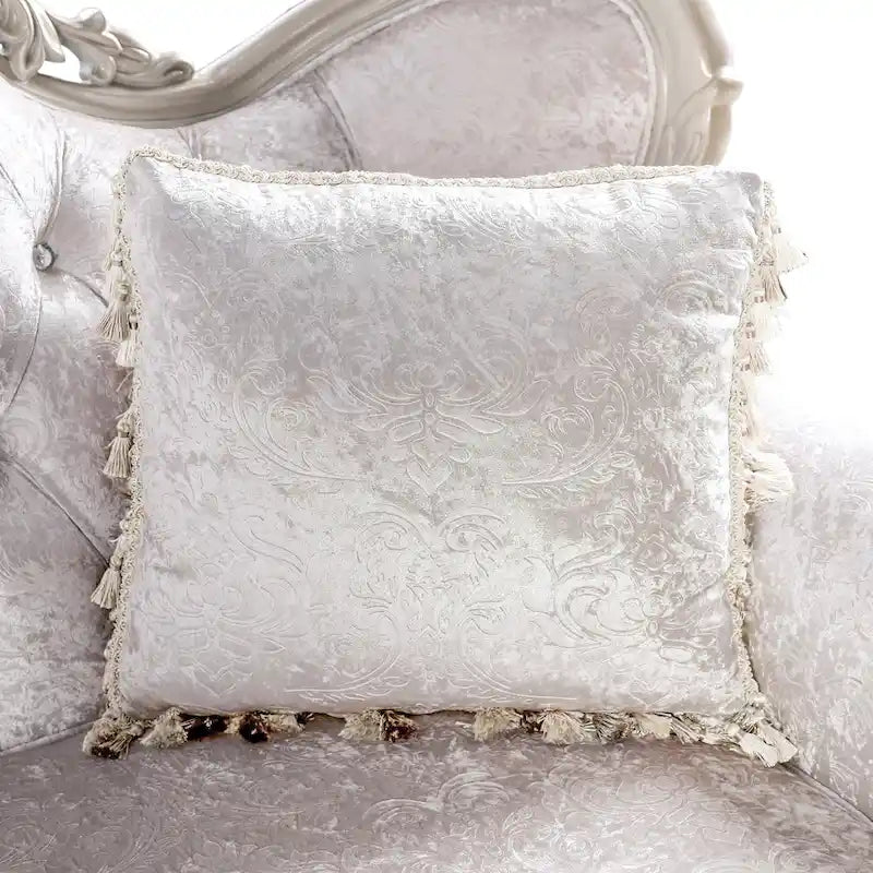 Traditional-style two-seater sofa featuring a button-tufted backrest and decorative throw pillows.