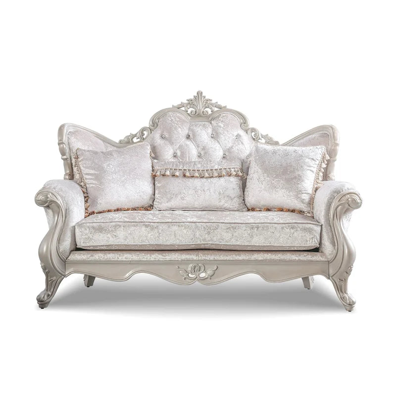 Traditional-style two-seater sofa featuring a button-tufted backrest and decorative throw pillows.