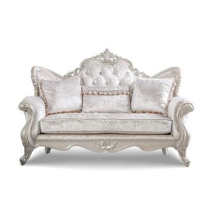 Traditional-style two-seater sofa featuring a button-tufted backrest and decorative throw pillows.