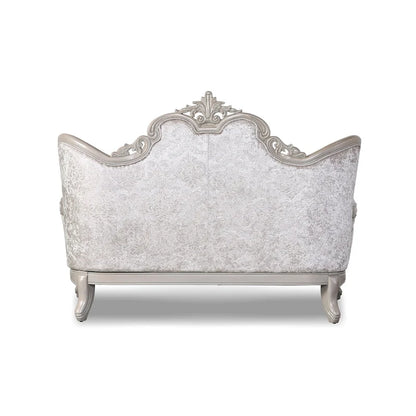 Traditional-style two-seater sofa featuring a button-tufted backrest and decorative throw pillows.
