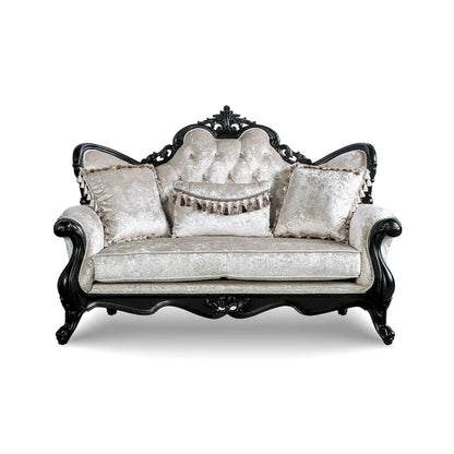Traditional-style two-seater sofa featuring a button-tufted backrest and decorative throw pillows.